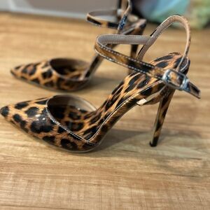 Leopard print patent leather closed toe heels.